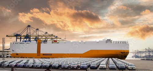Obraz na płótnie Close up vehicle carrier vessel loading car for shipping to worldwide, Large RoRo (Roll on off) vehicle car carrier, New car lined up in the port for import export around the world