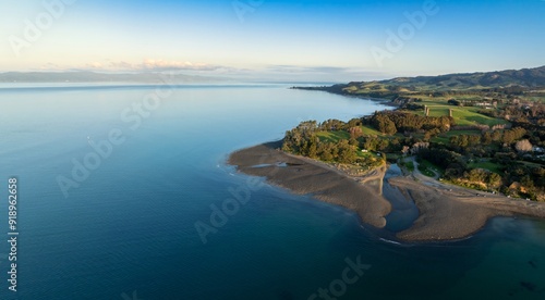 Shoreline of the Firth of Thames at sunset at Orere Point, Auckland, New Zealand.