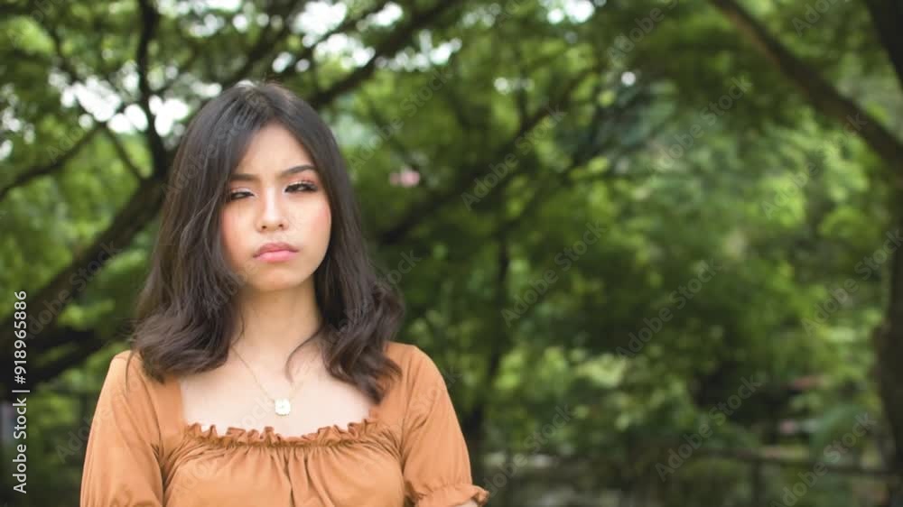 A grouchy young woman refuses to look after not hearing what she wants. Feeling upset at someone. Outdoor park scene. Slowed down 50 percent. A grouchy young woman refuses to look after not hearing what she wants. Feeling upset at someone. Outdoor park scene. Slowed down 50 percent.
