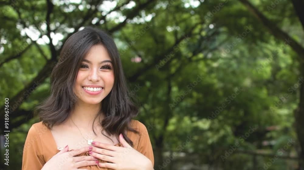 A friendly young asian lady introduces herself then offers a handshake. Bubbly lady establishing rapport. Outdoor park scene. Slowed down 50 percent. A friendly young asian lady introduces herself then offers a handshake. Bubbly lady establishing rapport. Outdoor park scene. Slowed down 50 percent.