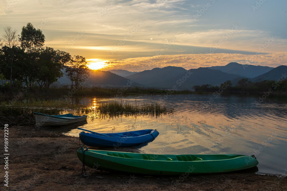 Beautiful landscape with reflection of mountain range on water during sunset at Tha Khoei reservoir in Ratchaburi, Thailand. Beautiful landscape with reflection of mountain range on water during sunset at Tha Khoei reservoir in Ratchaburi, Thailand.