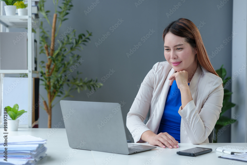 Asian businesswoman sitting in office stressed and fatigued from overwork on financial matters on office desk. Asian businesswoman sitting in office stressed and fatigued from overwork on financial matters on office desk.