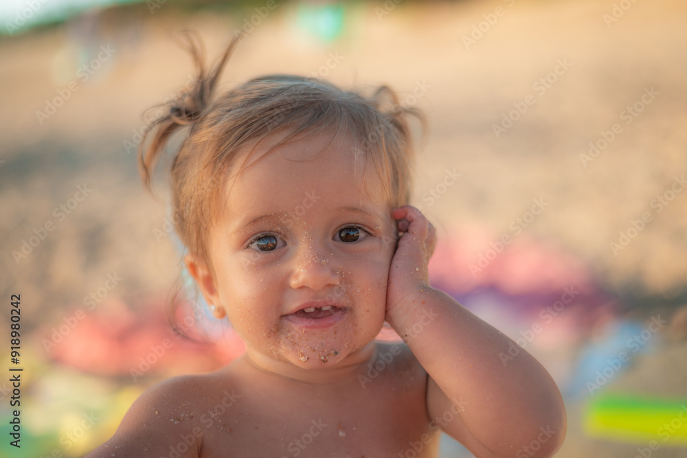 Adorable Smiling And Happy Baby Playing In The Sand At The Beach Adorable Smiling And Happy Baby Playing In The Sand At The Beach