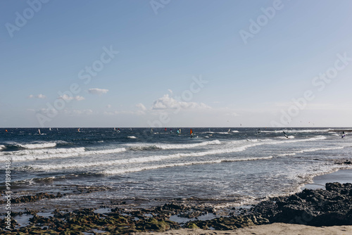 Man professional surfer standing on the sandy beach with his kite and board. Windsurfing, Extreme Sport photo