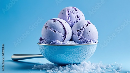 one scoop of blueberry ice cream, a large ice cream scoop with three blueberry ice cream scoops