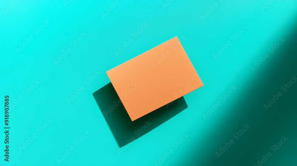 Orange empty card with copy space and shadow, set against a turquoise background.
