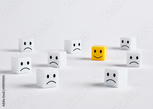 One happy yellow cube standing out from a crowd of unhappy white cubes