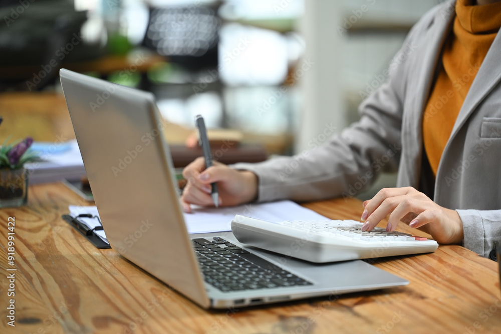 Businesswoman working on financial reports, budgeting or data entry at office desk Businesswoman working on financial reports, budgeting or data entry at office desk