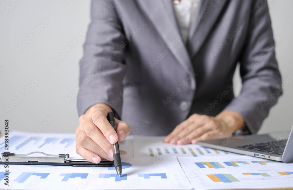 Asian businesswoman sit at their desks and calculate financial graphs showing results about their investments and plan successful business growth process Asian businesswoman sit at their desks and calculate financial graphs showing results about their investments and plan successful business growth process