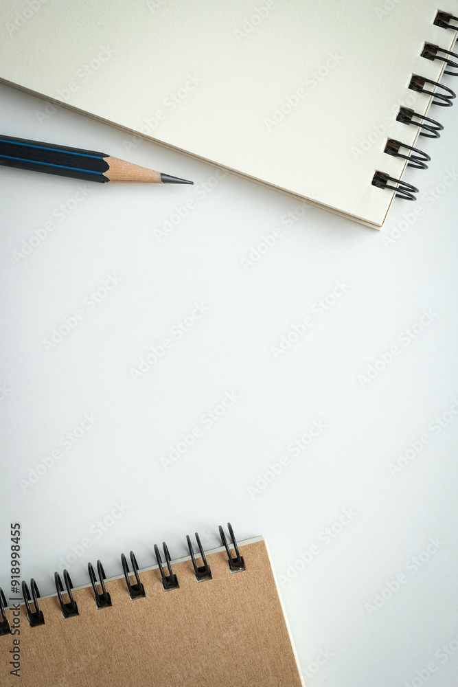 Open blank spiral notebook with black pencil on white background. Empty Space for your text. Open blank spiral notebook with black pencil on white background. Empty Space for your text.