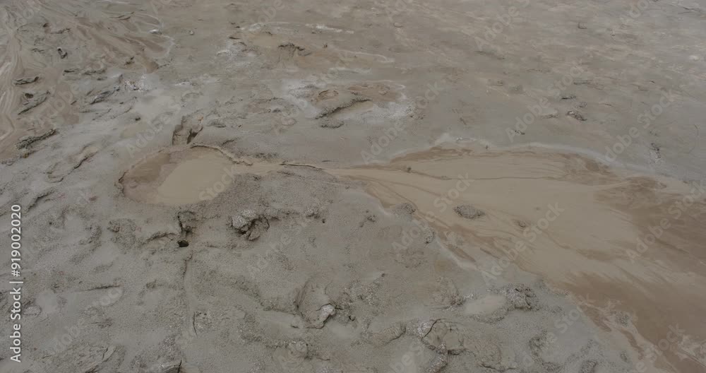 Muddy Vulcanos located in Buzau County, Romania, a National Landmark, Gas bubbles coming out a mud volcano. Paclele mici and Paclele Mari Muddy Vulcanos located in Buzau County, Romania, a National Landmark, Gas bubbles coming out a mud volcano. Paclele mici and Paclele Mari