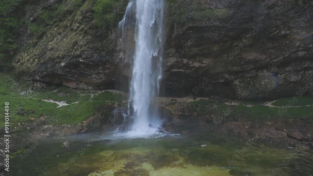 Fontanon of Goriuda, Udine. Wonderful waterfall that falls from a cliff. The force of the waterfall is a sight to behold. Hiking, trekking in the open area surrounded by woods. Summer holidays, peace.