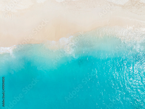 Fototapeta Naklejka Na Ścianę i Meble -  Tropical Beach with the soft wave water of the sea on the sandy beach background as texture with splashes and bubbles