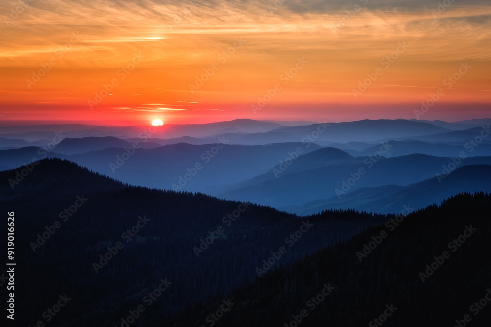 Amazing mountain landscape at sunrise, scenic view of silhouettes of the Carpathian mountains range, fantastic colorful sky with clouds and rising sun, outdoor travel background suitable for wallpaper Amazing mountain landscape at sunrise, scenic view of silhouettes of the Carpathian mountains range, fantastic colorful sky with clouds and rising sun, outdoor travel background suitable for wallpaper