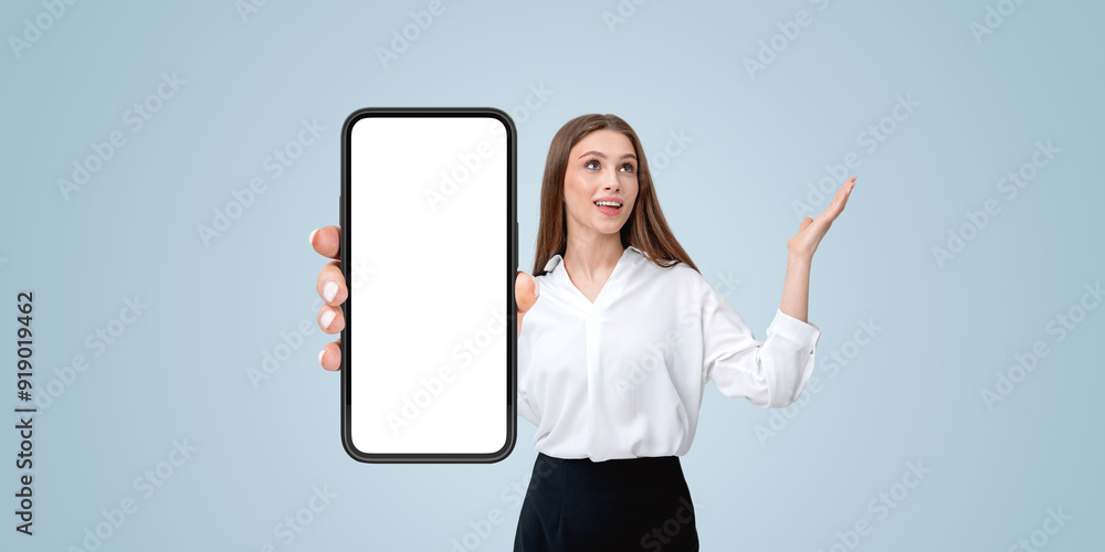 Woman holding a blank smartphone screen mockup, gesturing with h Woman holding a blank smartphone screen mockup, gesturing with h