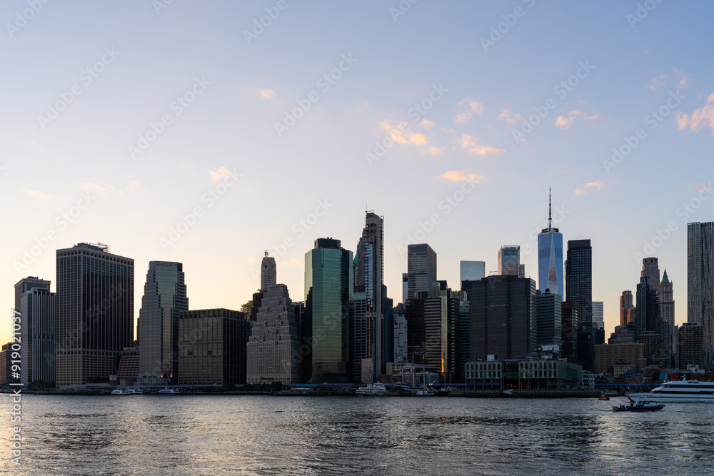 New York City skyline at sunset with waterfront view. New York City skyline at sunset with waterfront view.