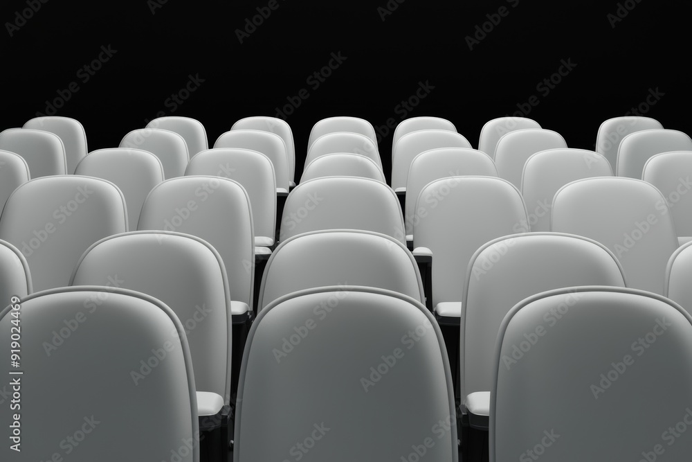 Fototapeta premium Empty rows of modern white chairs against a black background, ideal for presentations or events.