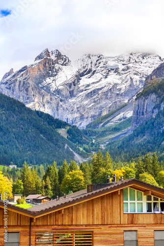 House in Kandersteg, snow mountains, Switzerland photo