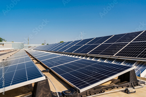 Solar panels installed on a rooftop, harnessing clean energy from the bright blue sky above. photo