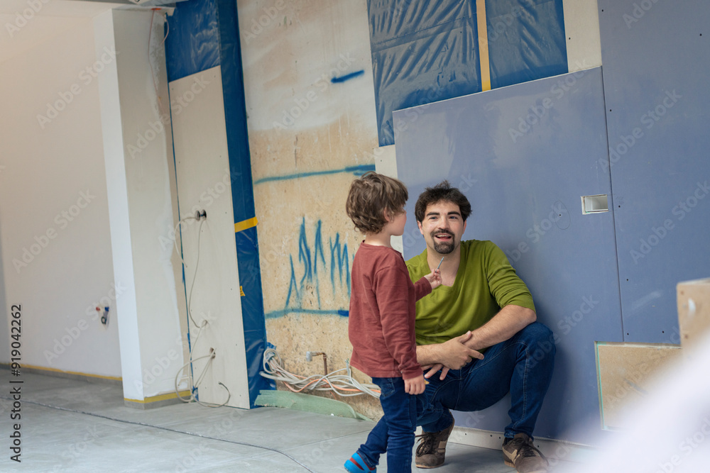Father and son spending leisure time in new apartment Father and son spending leisure time in new apartment
