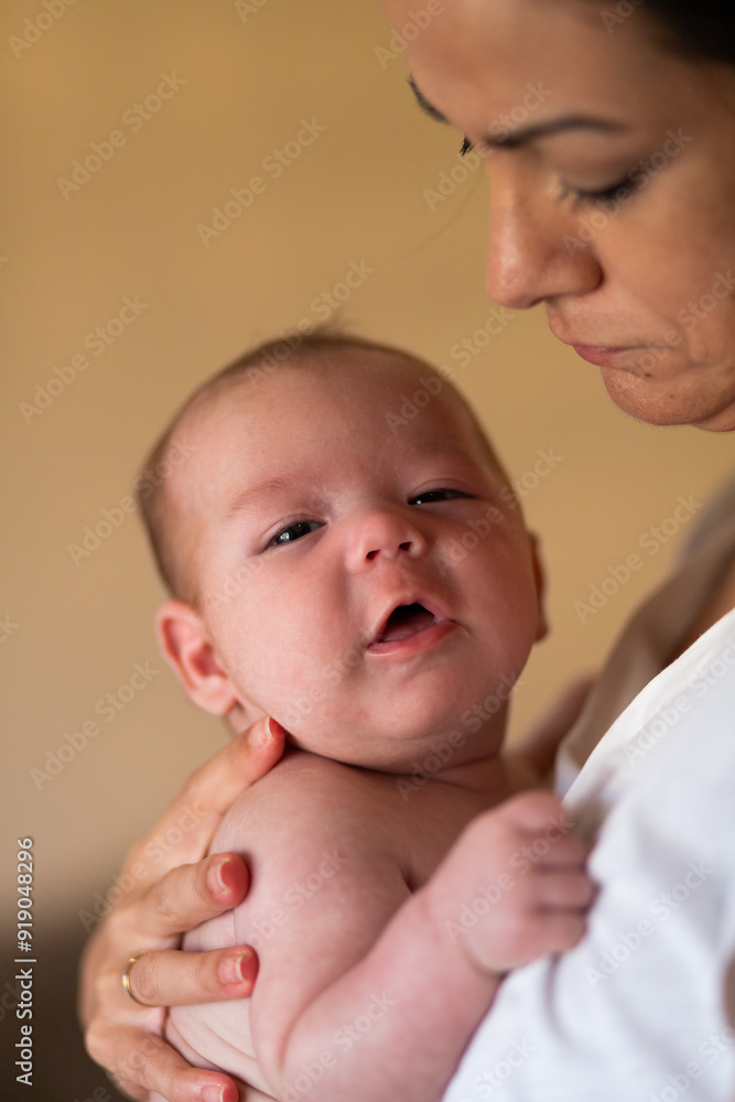 Loving mother hugging newborn at home Loving mother hugging newborn at home