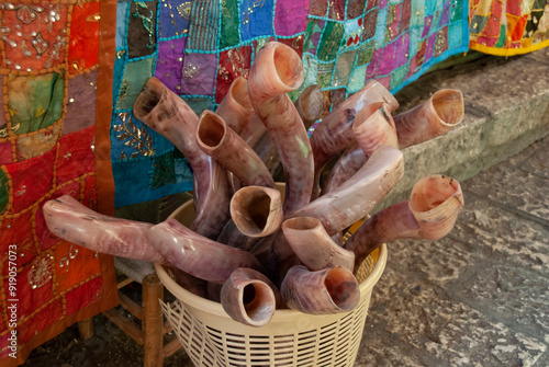 Basket filled with long, curly shofars carved from the horns of a kudu antelope and used to observe the Jewish new year holiday of Rosh Hashanah. photo