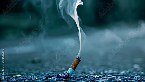 A lit cigarette releasing a thin column of smoke into the air, The thin column of smoke rising lazily from the forgotten cigarette photo