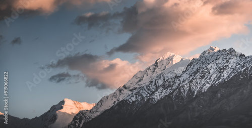 Panorama of the rocky mountain range of the Tien Shan with snow and glaciers in the evening at sunset in Pamir in Tajikistan, mountain landscape for the background photo