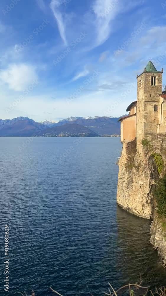 Beautiful view of the church in the cliffs, the Alps, and Lake Maggiore in Italy Beautiful view of the church in the cliffs, the Alps, and Lake Maggiore in Italy