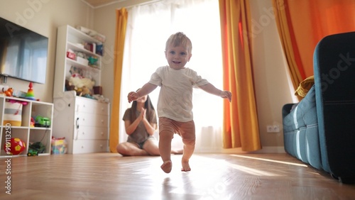 Billede på lærred The first steps baby of learning to walk in home