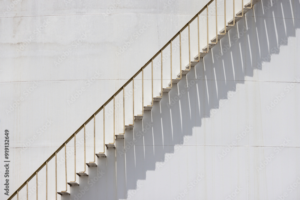 A white staircase with a shadow cast on the wall A white staircase with a shadow cast on the wall