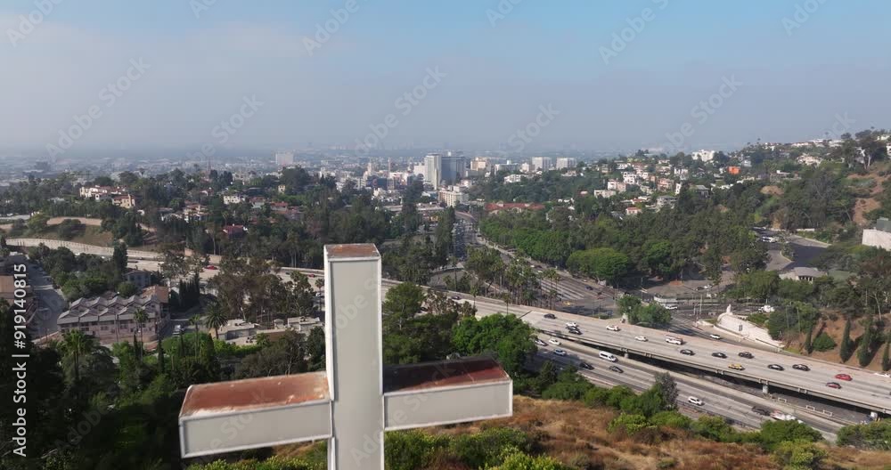 Aerial dolly over White Cross on hillside overlooking highway on outskirts of Los Angeles California Aerial dolly over White Cross on hillside overlooking highway on outskirts of Los Angeles California