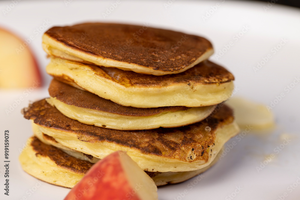 milk pancakes with butter and sliced peach slices milk pancakes with butter and sliced peach slices