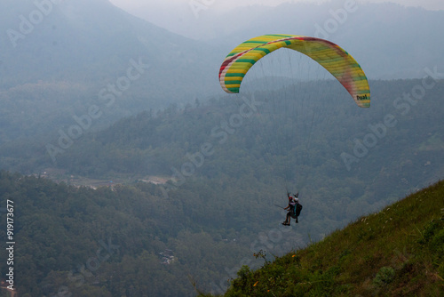 Some people are paragliding on a mountain with beautiful views