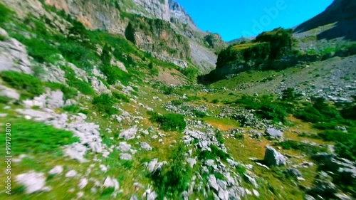 Fpv Drone diving the mountains, close up the rocks and green trees photo