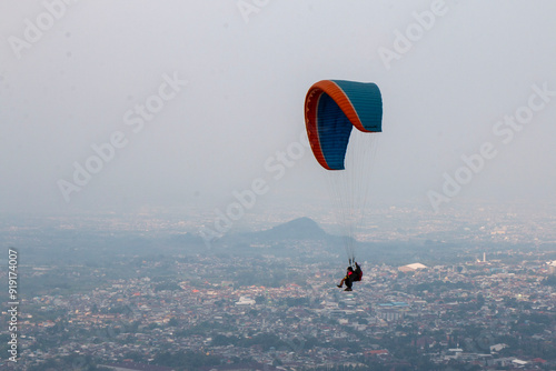 Some people are paragliding on a mountain with beautiful views