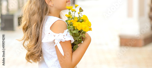 Banner happy Caucasian girl with a bouquet of yellow flowers. Childhood concept. Copy spaxe on  the right