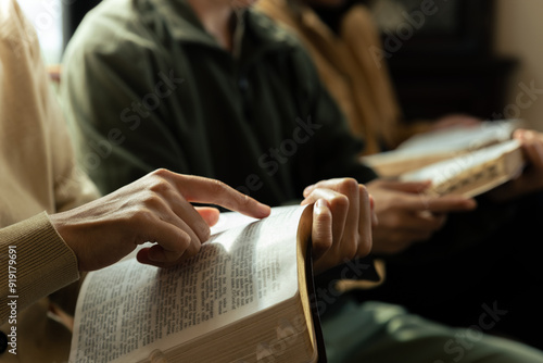 Christian group are praying to god with the bible and sharing the gospel.