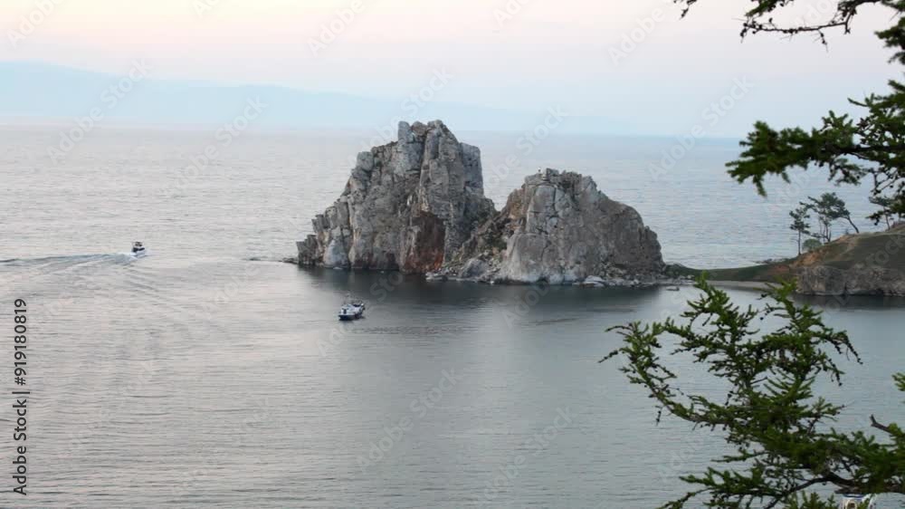 Baikal Lake. Video of Olkhon Island on summer evening. View of famous Shamanka Rock or Burkhan cape of Khuzhir village at sunset Baikal Lake. Video of Olkhon Island on summer evening. View of famous Shamanka Rock or Burkhan cape of Khuzhir village at sunset