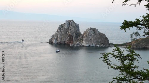 Baikal Lake. Video of Olkhon Island on summer evening. View of famous Shamanka Rock or Burkhan cape of Khuzhir village at sunset photo