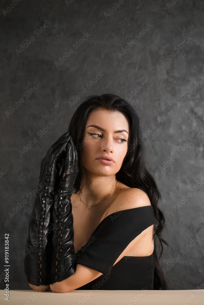 Beautiful dark-haired woman in black long gloves Beautiful dark-haired woman in black long gloves
