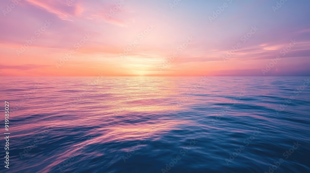 Fototapeta premium Stunning view of a calm ocean with a colorful sunset reflecting on the water