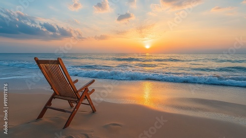 Relaxing on the Beach A Deck Chair Facing the Sunset with Gentle Waves  Perfect for a Tranquil Vacation or Summer Escape This Photo Captures the Essence of Coastal Serenity and Tranquility Enjoy the