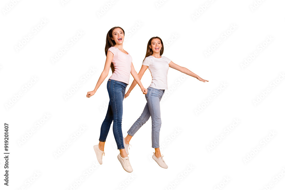 Full length body size view portrait of nice charming lovely attractive cheerful cheery straight-haired ladies strolling free time isolated over bright vivid shine yellow background Full length body size view portrait of nice charming lovely attractive cheerful cheery straight-haired ladies strolling free time isolated over bright vivid shine yellow background
