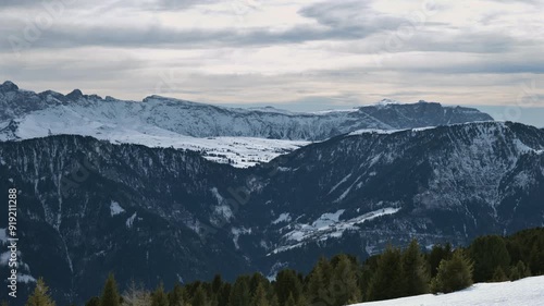 Wallpaper Mural Expansive view of a snowy mountain range with forested hills and a cloudy sky. Torontodigital.ca
