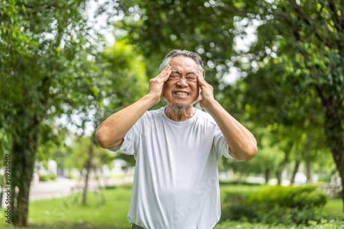 Sick unhappy senior elderly man touching head serious depressed feeling headache thinking of problem, alzheimer, cancer, stroke, parkinson, disease and cerebral haemorrage.