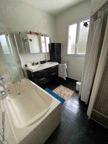 bathroom with mirror bath and equipment