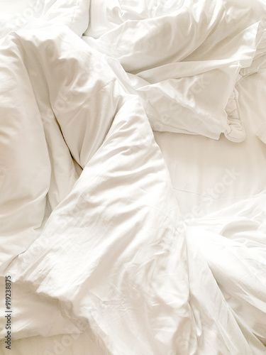 white pillows and sheet on the bed photo