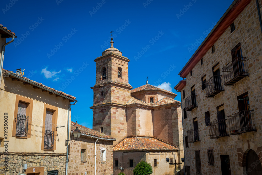 Side view of the parish church of Santa María, Sigüenza, Guadalajara, Castilla-La Mancha, Spain, with its bell tower as the main attraction from the streets of the town. Side view of the parish church of Santa María, Sigüenza, Guadalajara, Castilla-La Mancha, Spain, with its bell tower as the main attraction from the streets of the town.