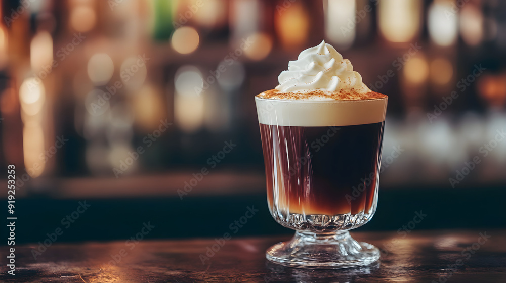 A macro shot of a classic irish coffee highlights rich layers of coffee and cream topped with whipped cream and a sprinkle of cocoa A macro shot of a classic irish coffee highlights rich layers of coffee and cream topped with whipped cream and a sprinkle of cocoa